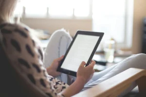 Woman reading in her tablet